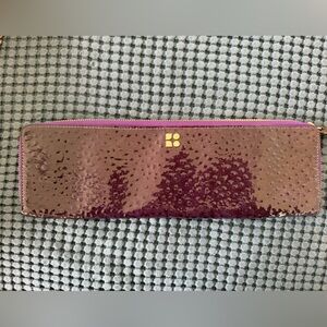 Kate Spade zip-around wallet with an ostrich-embossed patent leather finish